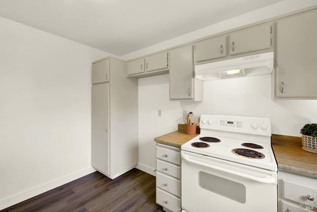 kitchen featuring under cabinet range hood, dark wood-type flooring, baseboards, light countertops, and white electric range oven