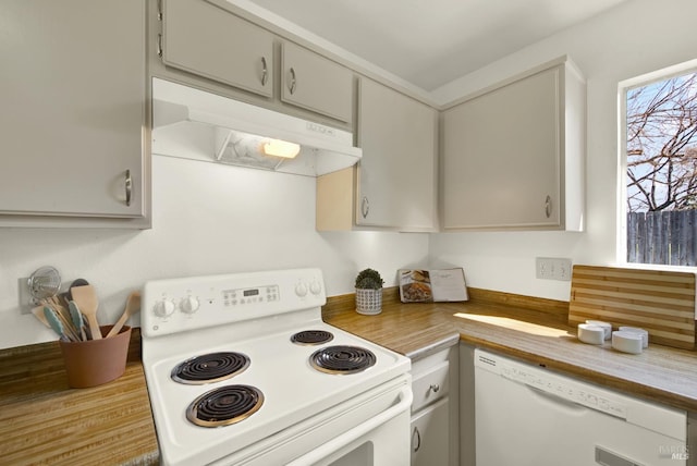 kitchen featuring white appliances and under cabinet range hood