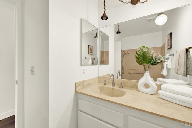 full bath featuring a shower and vanity