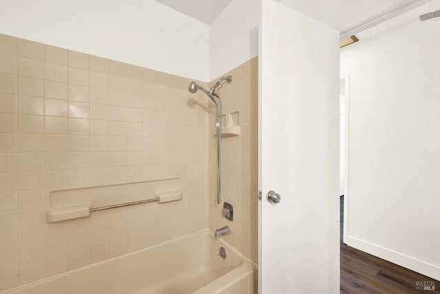 full bath featuring  shower combination, baseboards, and wood finished floors