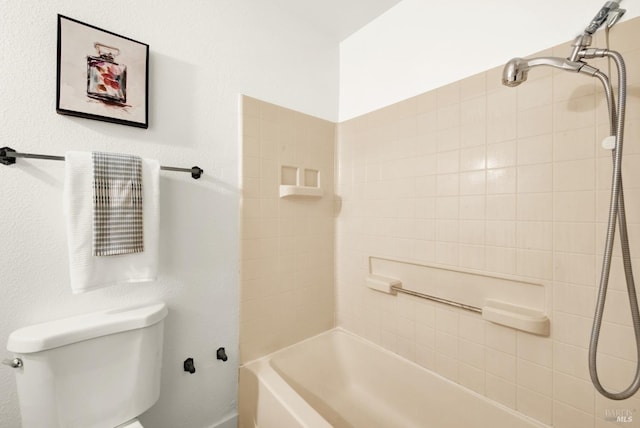 bathroom featuring shower / bath combination and toilet