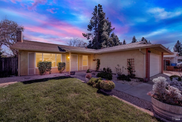 ranch-style home with a garage, a chimney, fence, a front lawn, and stucco siding