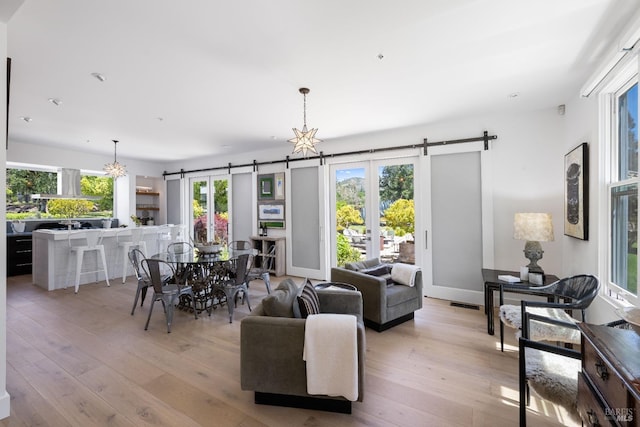 100 W Trinity Rd, Glen Ellen, CA 95442 - living room featuring a barn door, light wood finished floors, and a chandelier