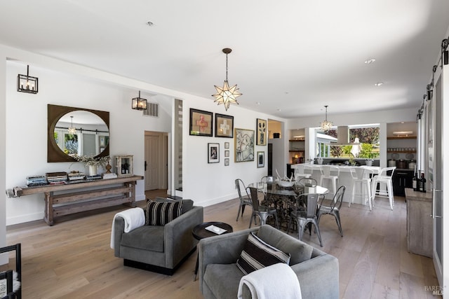 100 W Trinity Rd, Glen Ellen, CA 95442 - living room featuring a barn door, light wood-style floors, and baseboards