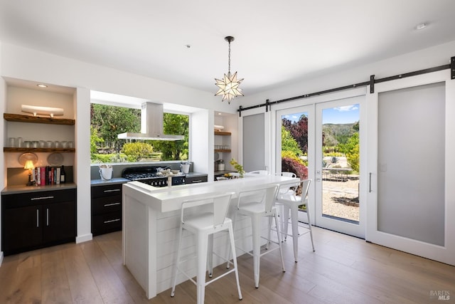 100 W Trinity Rd, Glen Ellen, CA 95442 - kitchen with wall chimney range hood, open shelves, a barn door, and plenty of natural light