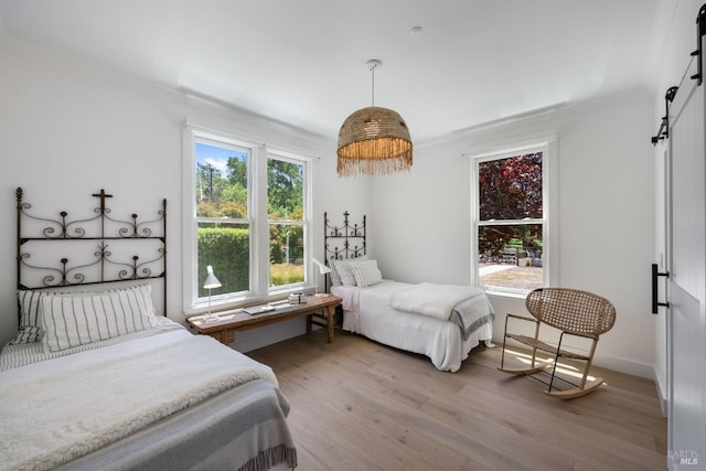100 W Trinity Rd, Glen Ellen, CA 95442 - bedroom featuring a barn door and light wood-style floors