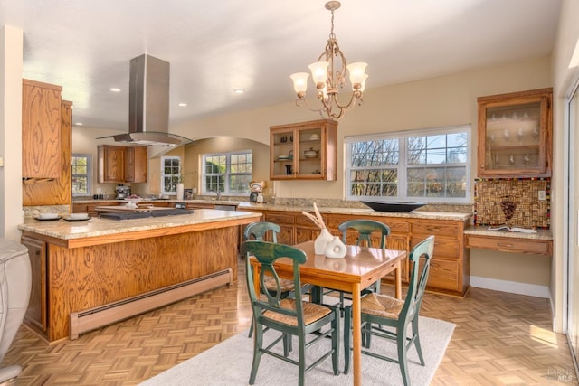 dining room featuring arched walkways, plenty of natural light, baseboard heating, and recessed lighting