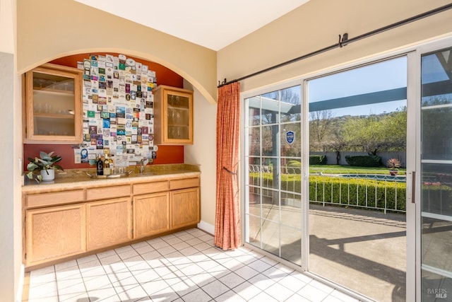 doorway featuring light tile patterned flooring