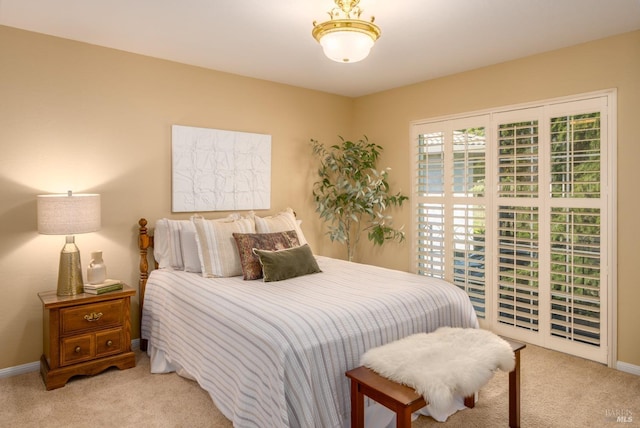 bedroom featuring light carpet and baseboards