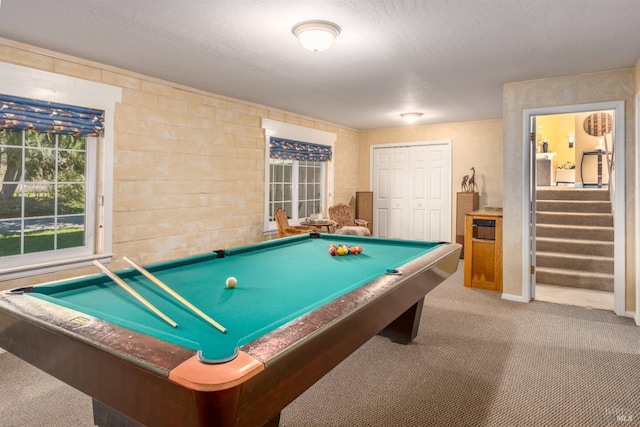 rec room with a textured ceiling, carpet floors, and pool table