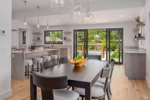 dining room featuring plenty of natural light, light wood-style flooring, and recessed lighting