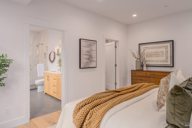 bedroom featuring recessed lighting and connected bathroom