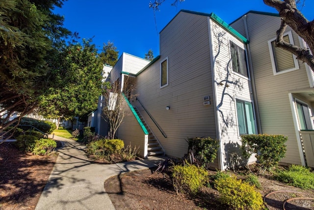 view of side of property featuring stairway