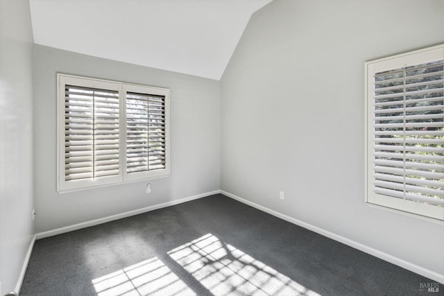 unfurnished bedroom with vaulted ceiling, carpet flooring, and baseboards