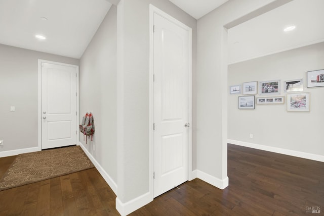 hall with recessed lighting, hardwood / wood-style flooring, and baseboards