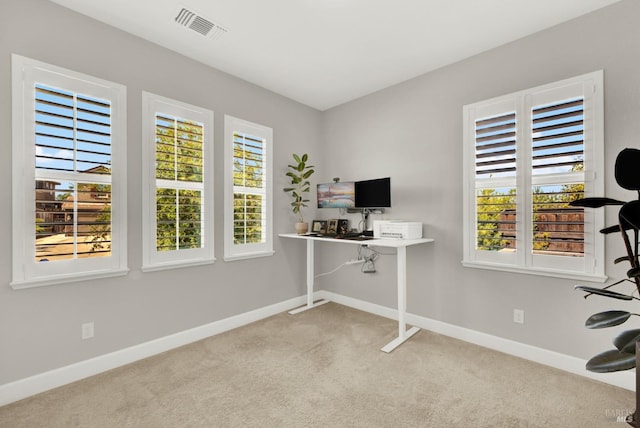 office featuring carpet, visible vents, and baseboards