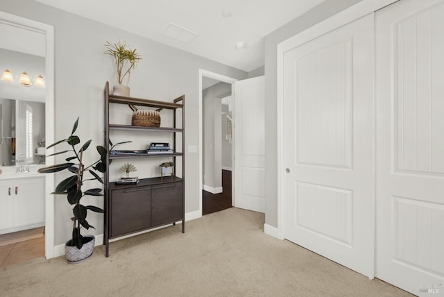 hallway with light carpet and baseboards