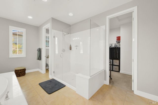 full bath with tile patterned flooring, a shower stall, toilet, and baseboards