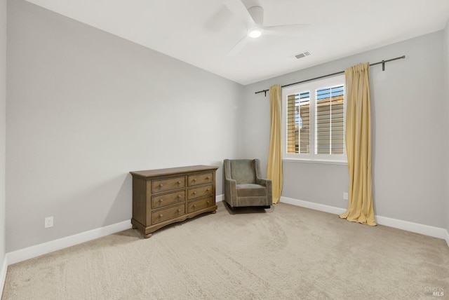 living area featuring ceiling fan, light carpet, visible vents, and baseboards