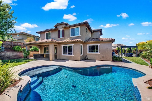 back of house featuring a patio, a fenced backyard, a tile roof, a pergola, and stucco siding