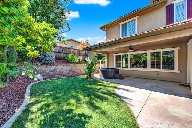 view of yard featuring a patio, fence, and a ceiling fan