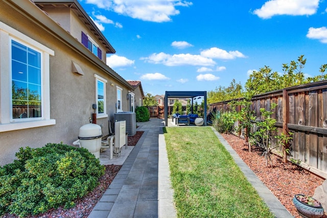 view of yard featuring central air condition unit, a patio area, and a fenced backyard