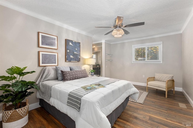 bedroom with crown molding, a textured ceiling, baseboards, and wood finished floors