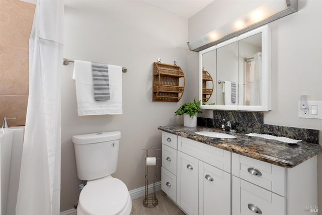 bathroom with toilet, baseboards, a shower with shower curtain, and vanity