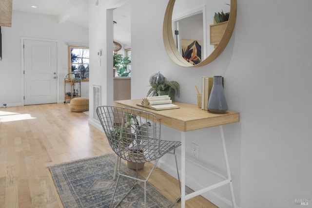 entryway featuring vaulted ceiling with beams, baseboards, and wood finished floors