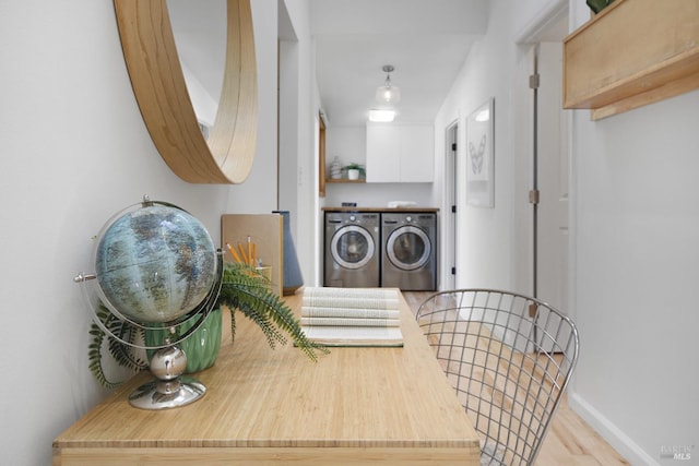 washroom with baseboards, laundry area, and washer and dryer