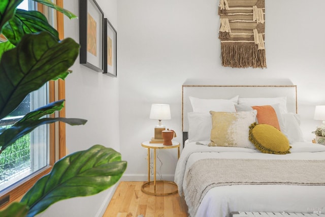 bedroom featuring baseboards and wood finished floors