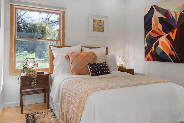 bedroom featuring baseboards and wood finished floors