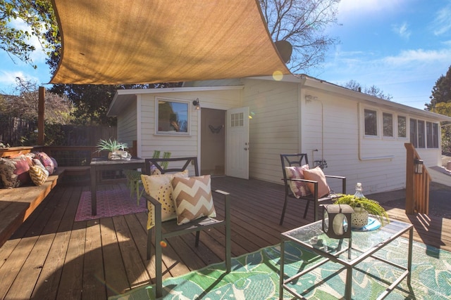 wooden deck with fence and an outdoor living space