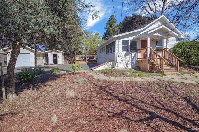 view of front of property with a garage and an outbuilding