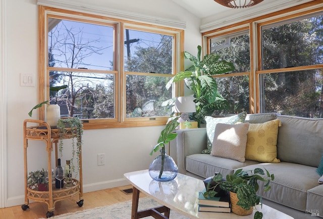 sunroom / solarium featuring vaulted ceiling