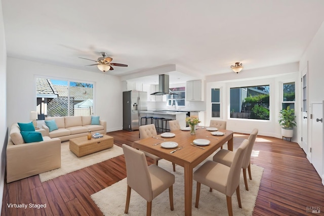 dining space featuring ceiling fan, baseboards, and wood finished floors