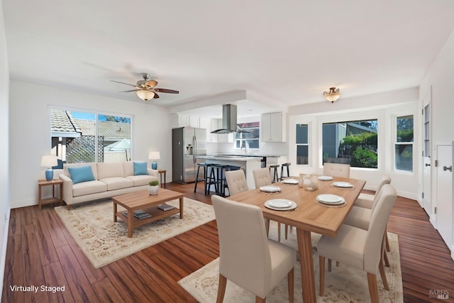 dining area with dark wood-style floors, a ceiling fan, and baseboards