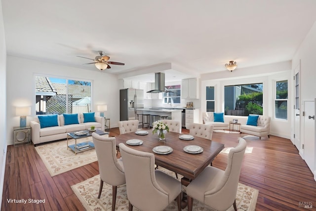 dining area with wood-type flooring and ceiling fan