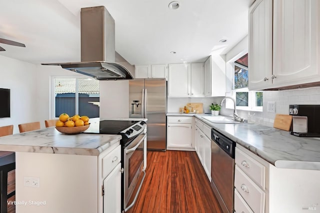 kitchen featuring stainless steel appliances, tasteful backsplash, a sink, a kitchen island, and island range hood