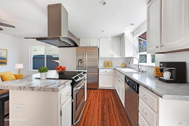 kitchen with a center island, island exhaust hood, stainless steel appliances, backsplash, and a sink