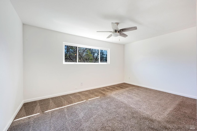 empty room with carpet, ceiling fan, and baseboards