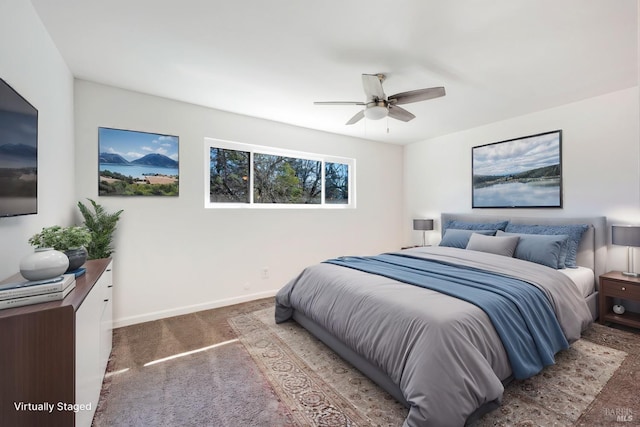 carpeted bedroom featuring ceiling fan and baseboards