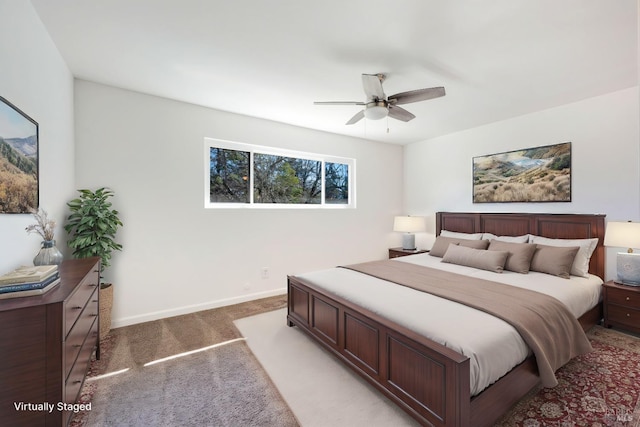 bedroom featuring light colored carpet, ceiling fan, and baseboards