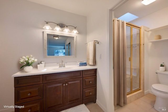 full bath featuring tile patterned flooring, a shower stall, toilet, and vanity