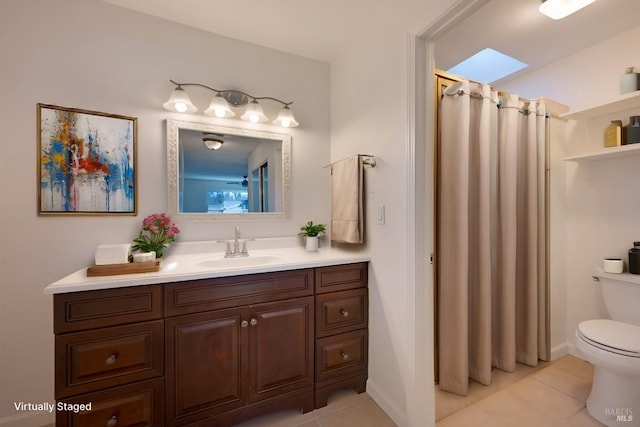 bathroom with vanity, curtained shower, tile patterned flooring, and toilet