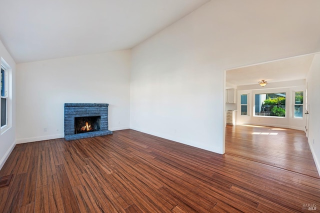 unfurnished living room with high vaulted ceiling, visible vents, baseboards, a brick fireplace, and dark wood finished floors