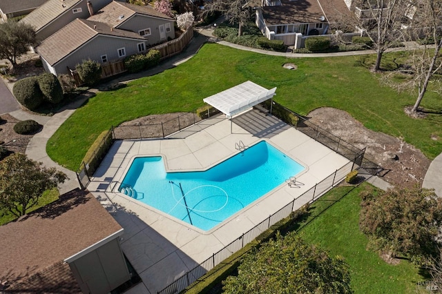 view of pool with a patio, a lawn, and fence