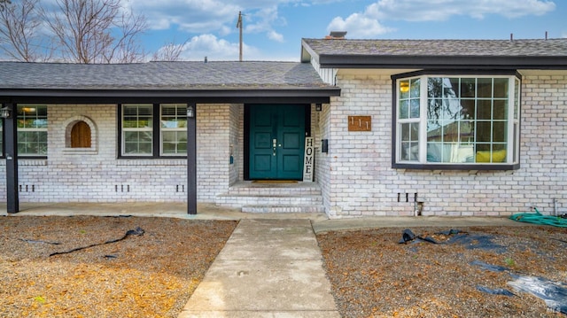 view of front of property featuring brick siding and crawl space