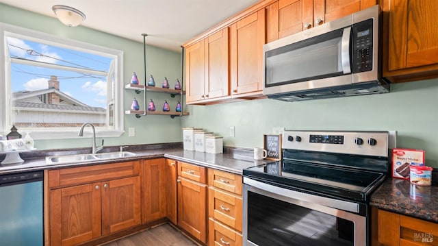 kitchen featuring a sink, appliances with stainless steel finishes, and brown cabinetry