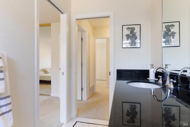 bathroom featuring a sink and ensuite bathroom